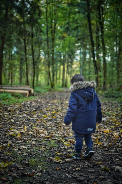 young child walking alone in an out door park