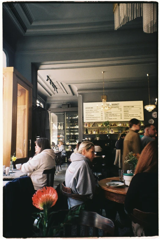 a group of people sitting at a table in a restaurant