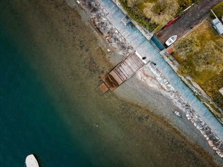 an aerial view of two boats docked at a dock