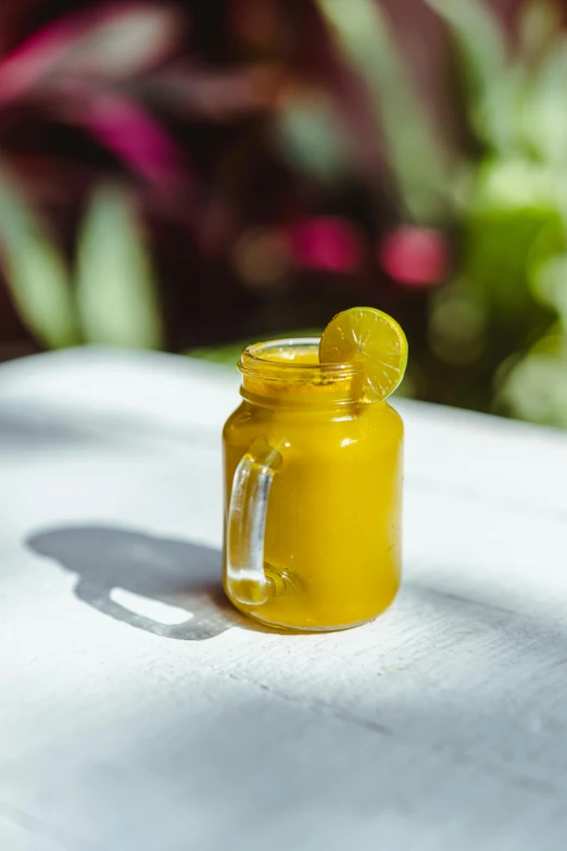 a glass jar filled with a lemon and ice cream