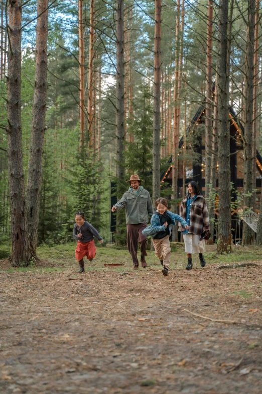 a group of people running through the woods