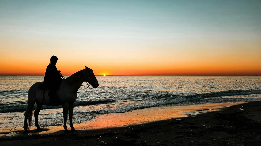 a man that is sitting on top of a horse