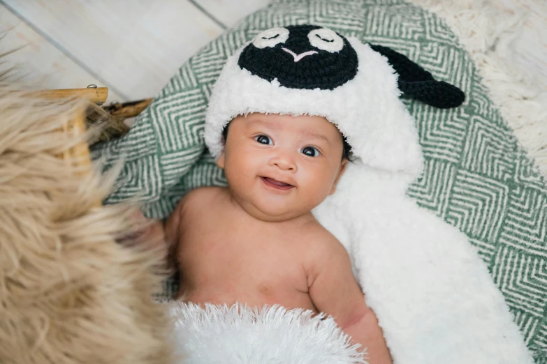 a small baby wearing a sheep hat