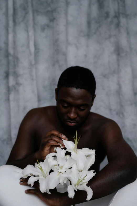 a man sitting on top of a white towel