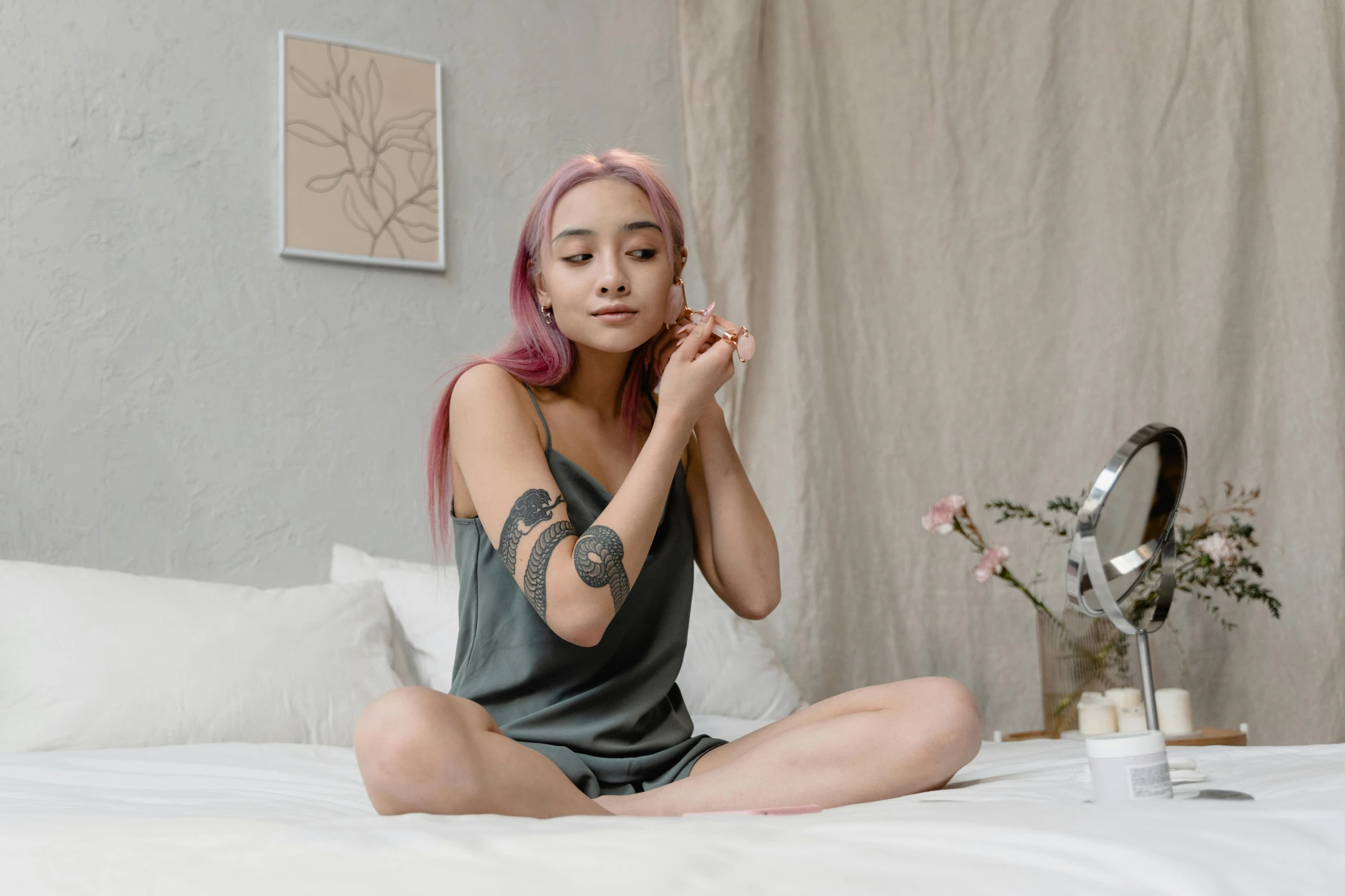 a woman sitting on her bed in a pose