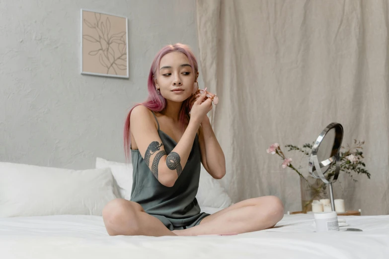 a woman sitting on her bed in a pose