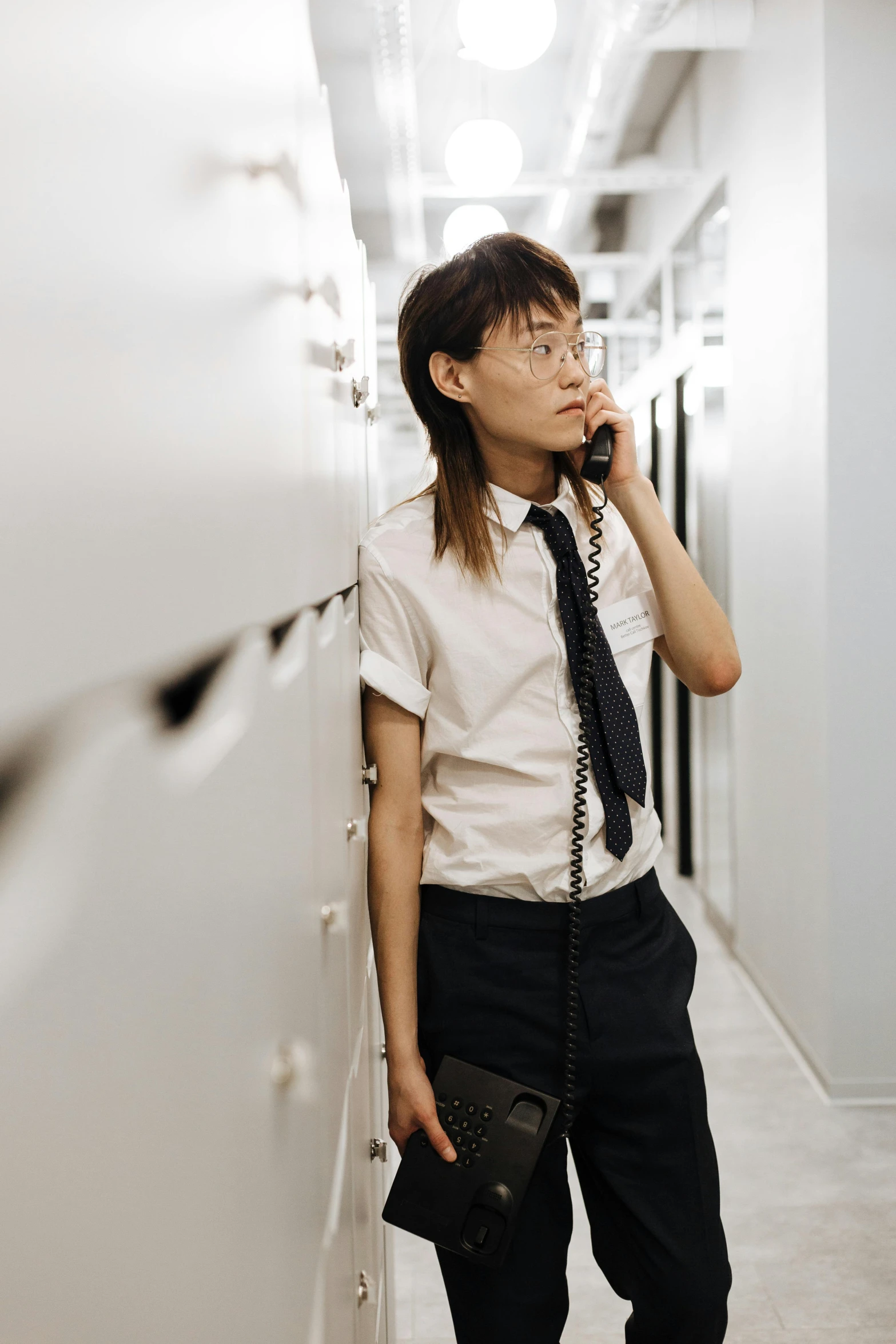 a woman talking on a cell phone in the hallway