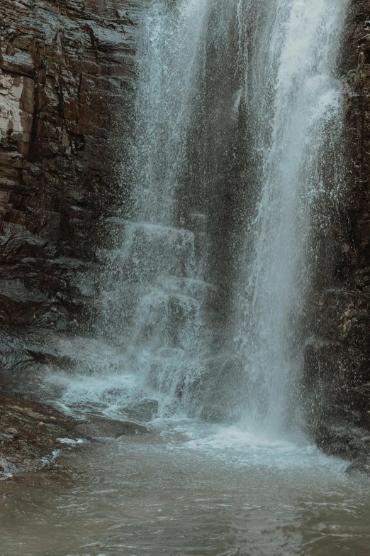 a waterfall with some water pouring over it