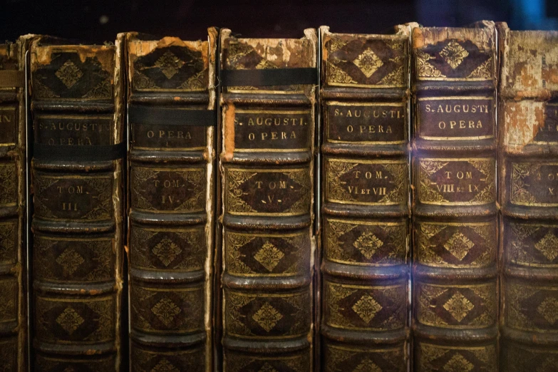 a bunch of old book that are sitting on a table