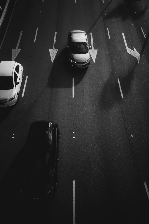 an overhead view of a street with cars driving on it