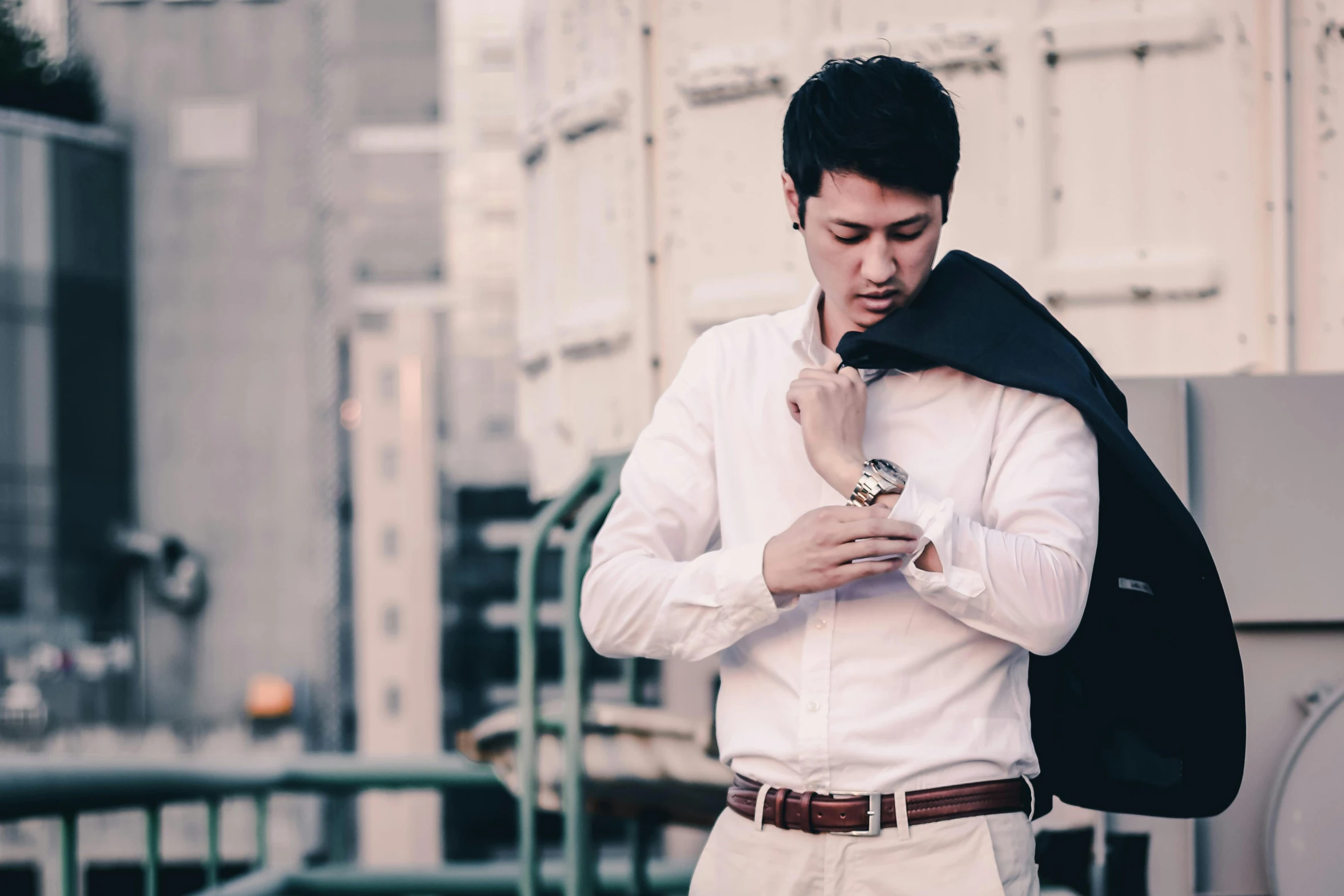 a man holding his tie and looking down