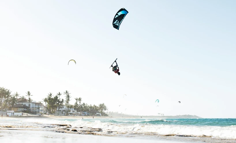 kite surfers doing aerial tricks in the ocean