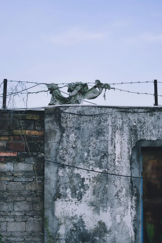 there is a barbed wire and an old wall