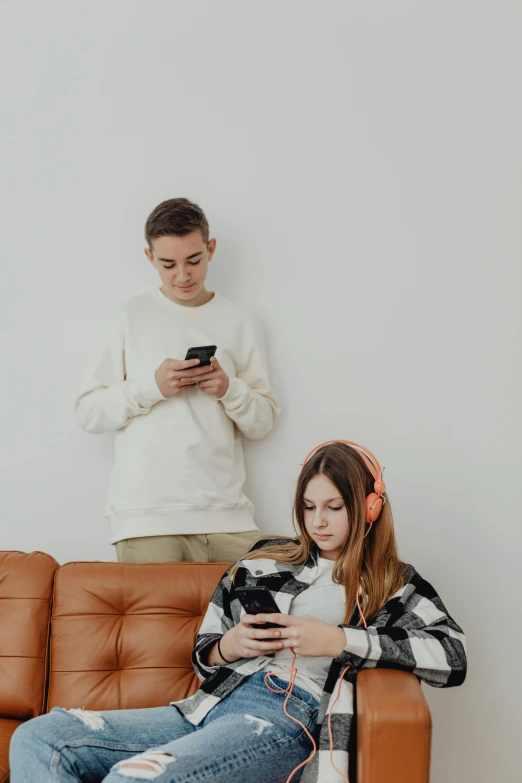 a person using a cell phone while another watches