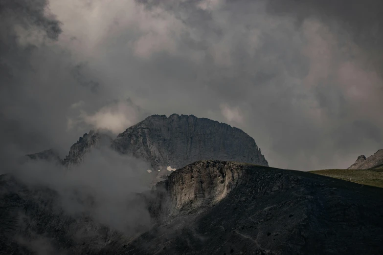 this is a view of a mountain with dark clouds