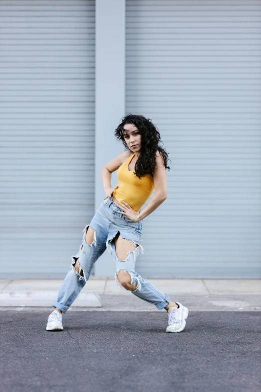 a woman with ripped jeans walking on the street