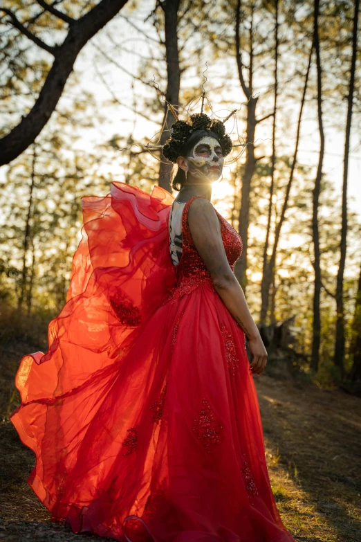 a girl in a red dress is dressed up and posing