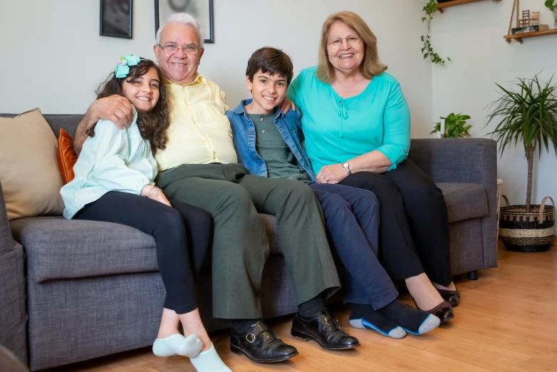 a woman, woman and child sitting on a couch