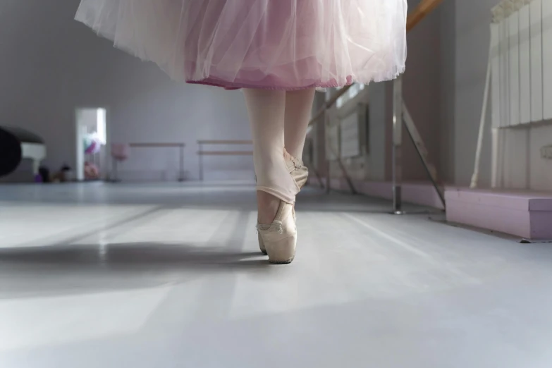 a ballerina's feet are shown in a dress