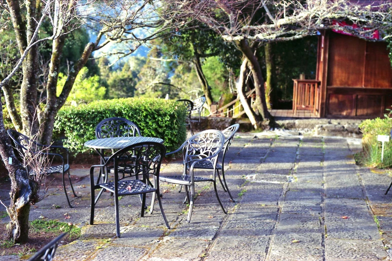 the table and chairs have been set on a stone patio