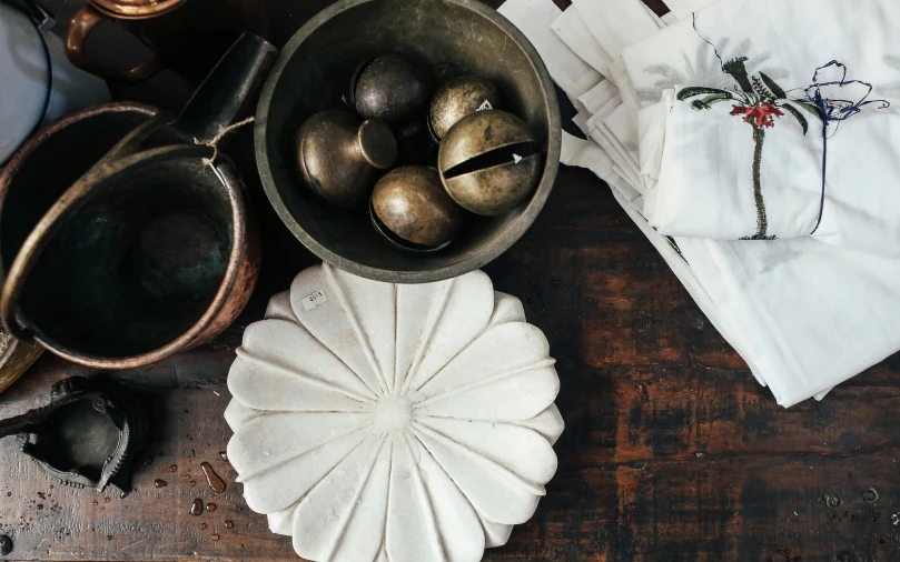 a bowl full of brown eggs on top of a white napkin