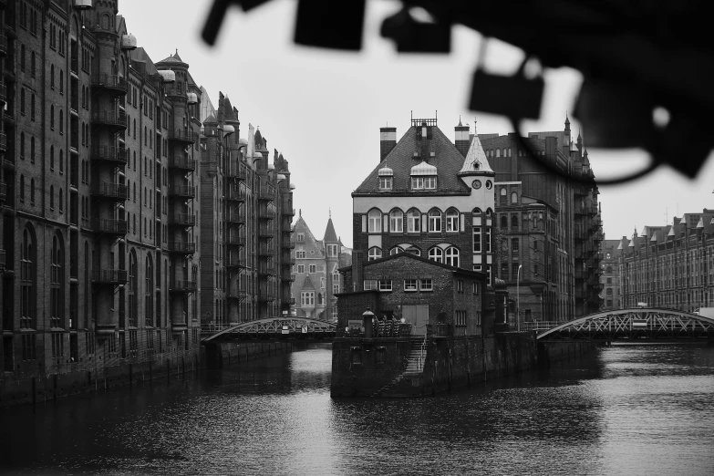 a view of a city with an old bridge and the water