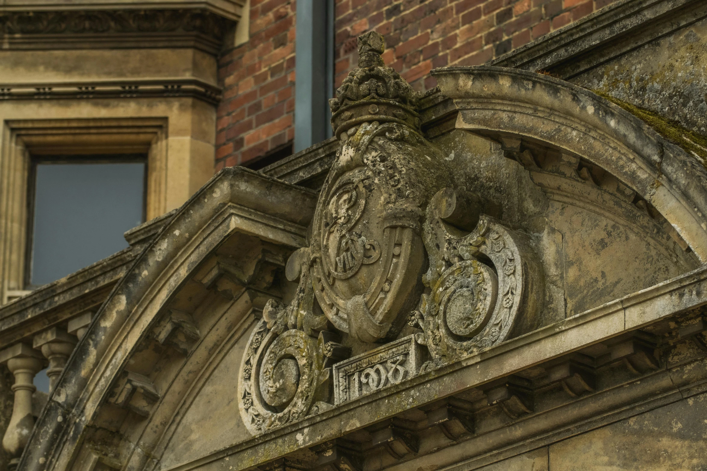 old building with a brick wall and decorative iron decoration