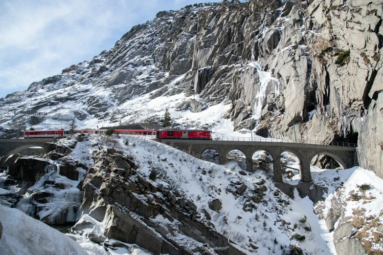 a train riding across a snowy mountain top