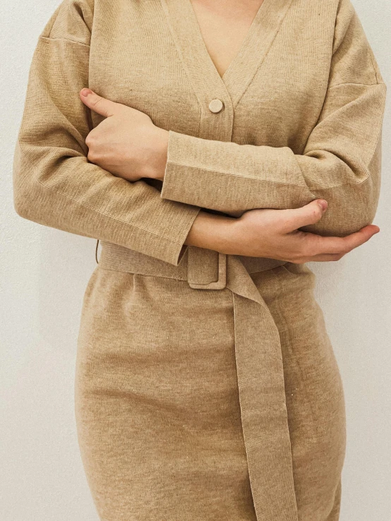 woman in brown cardigan with arms crossed