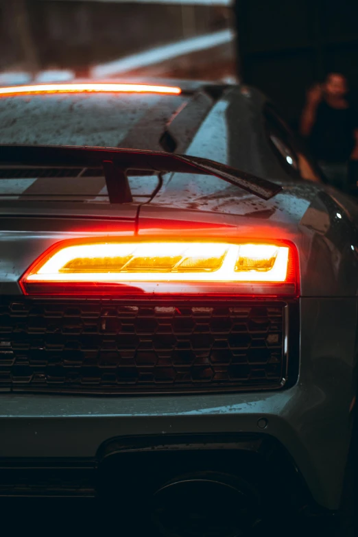 close up on the tail lights of a car in a parking lot