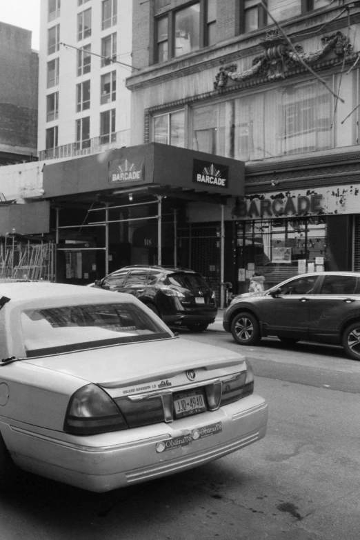 an old black and white po of cars on the street