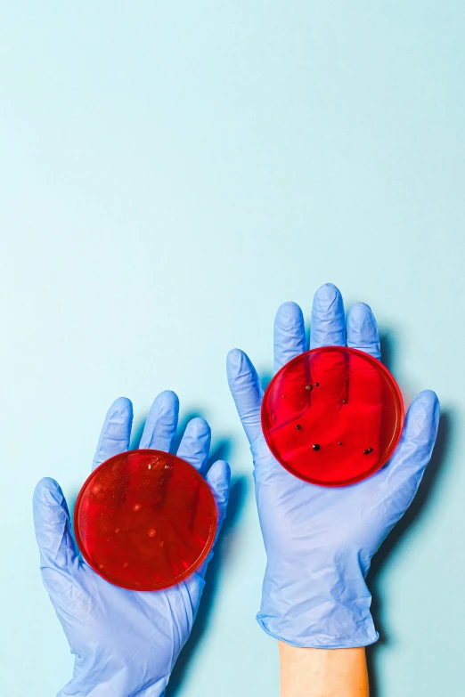 a hand holding an object with two red dots on it