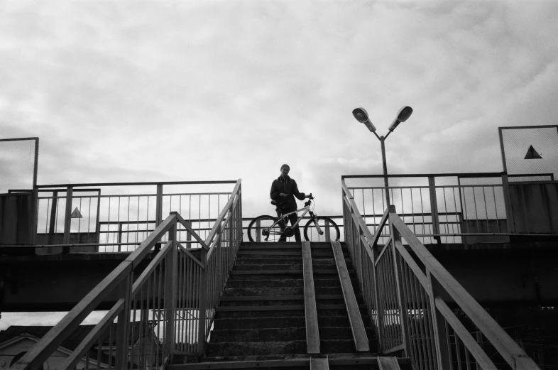 the bike rider is riding down the stairway