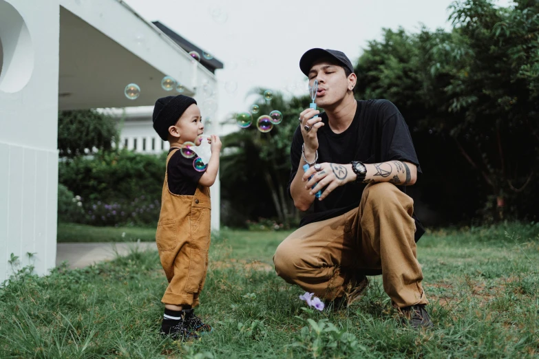 a  blows soap bubbles on his finger