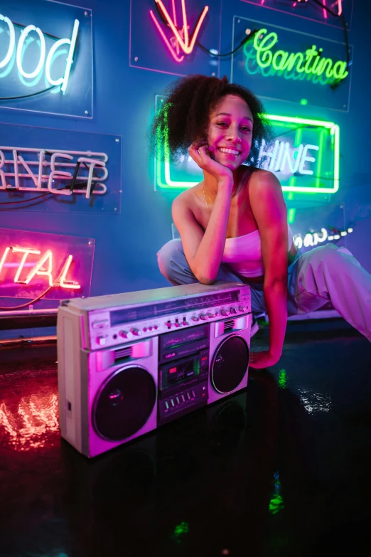 a  sits on a stereo in front of neon signs