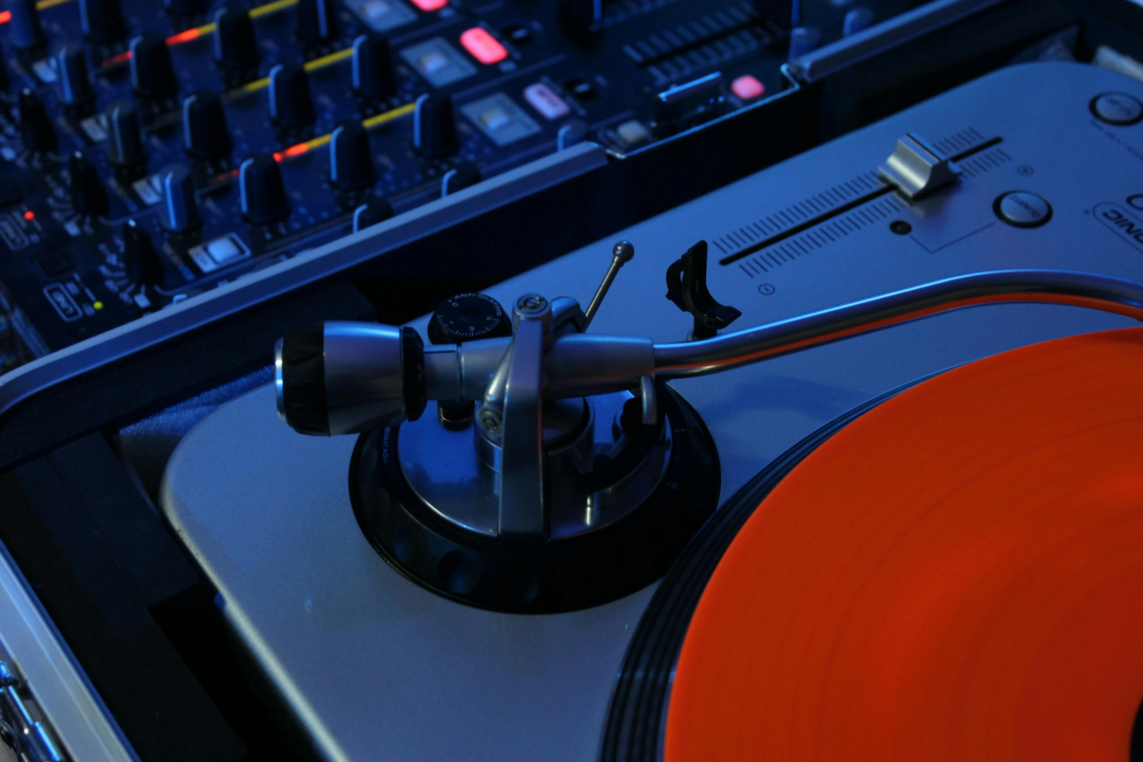 an image of a dj mixing equipment at a party