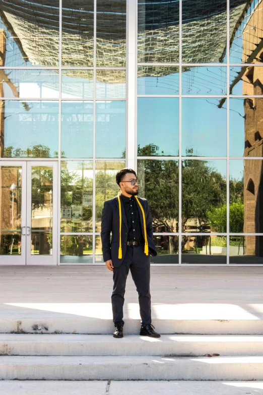 the man standing on the steps near a large building