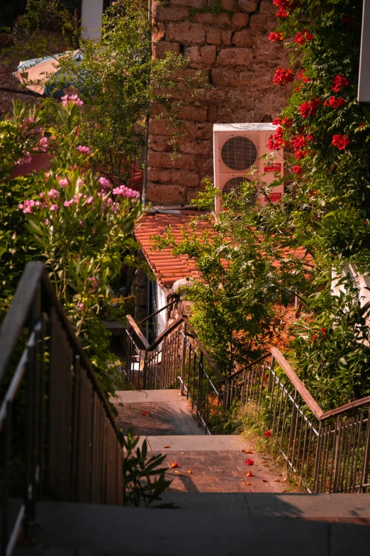 the stairs to a building lead up to a stone wall