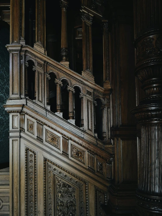 ornately carved and wooden balconies and railings against a dark green wall