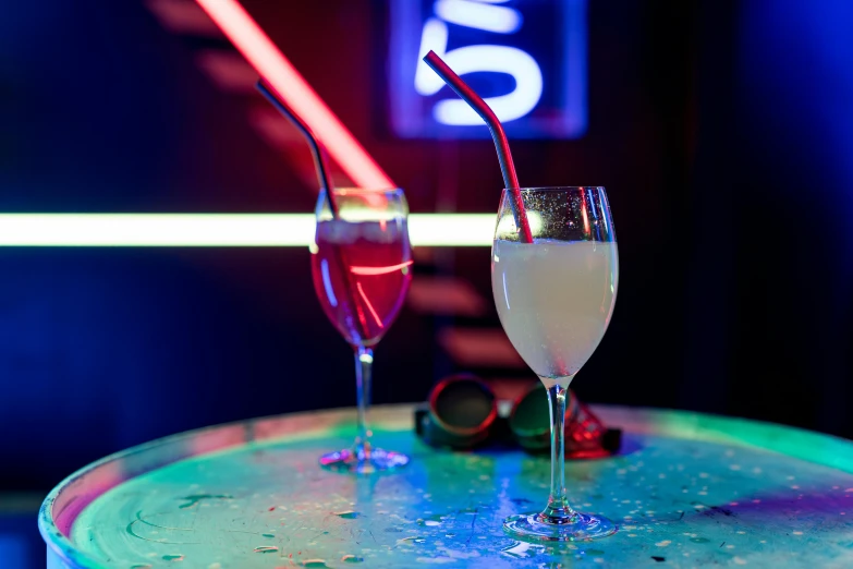 a pair of glasses on a table, with drinks nearby