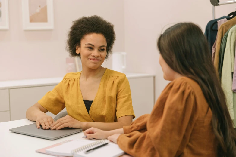 a woman and another woman sit at a table