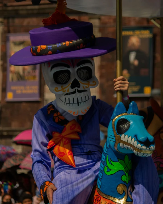 a colorful skeleton sitting on a large animal statue