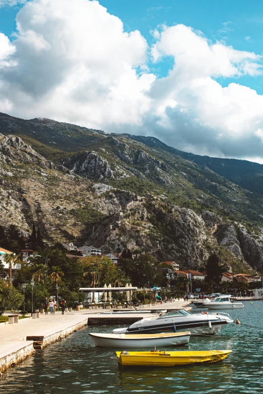 several boats are in the water near some mountains