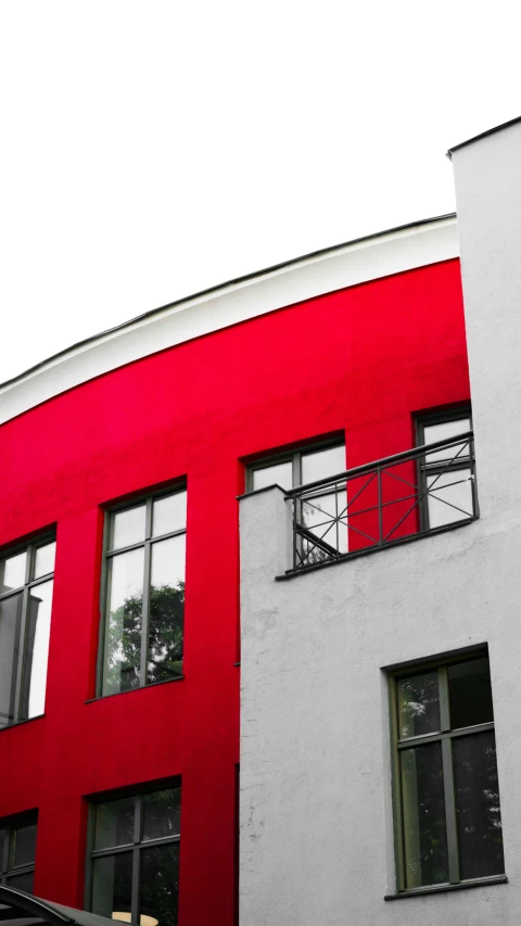 red and grey building with balcony area on a sunny day