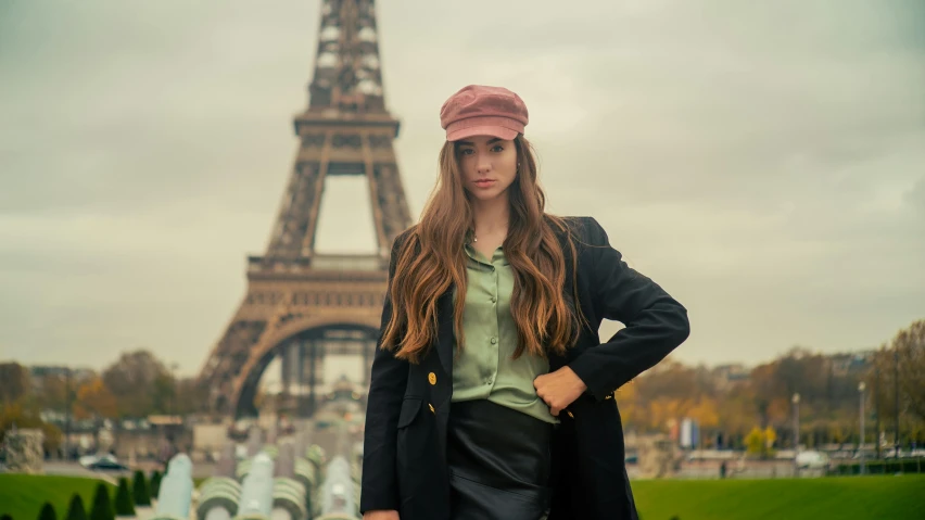 the girl is standing by the water looking at the camera