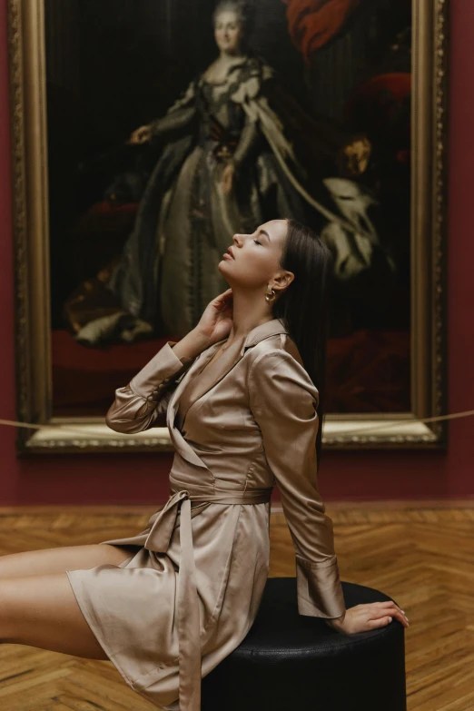 a woman is posing in front of a portrait