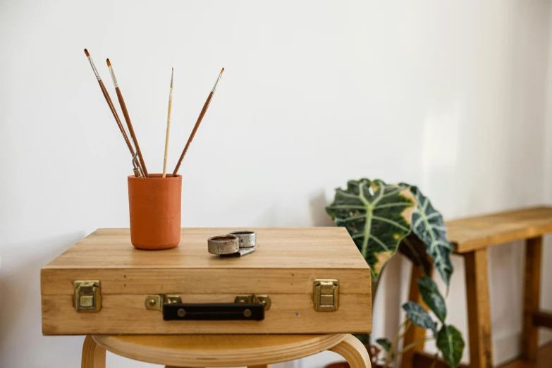 a wooden box sitting next to an ottoman