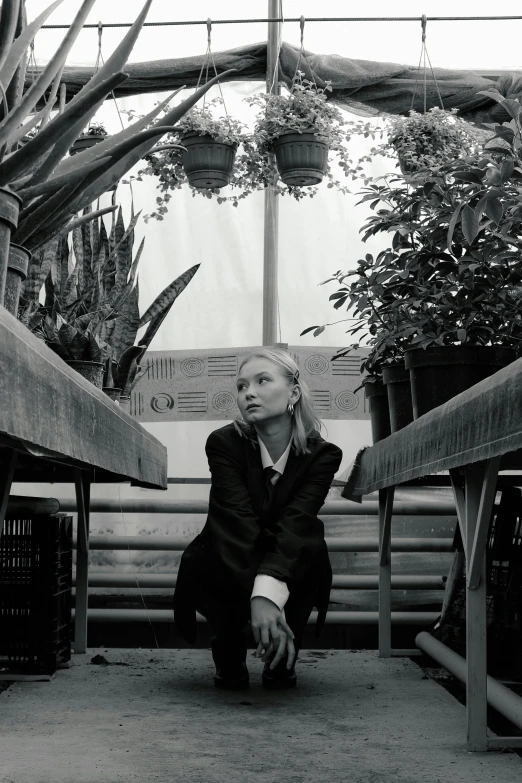 a black and white po of a woman crouching down in a store