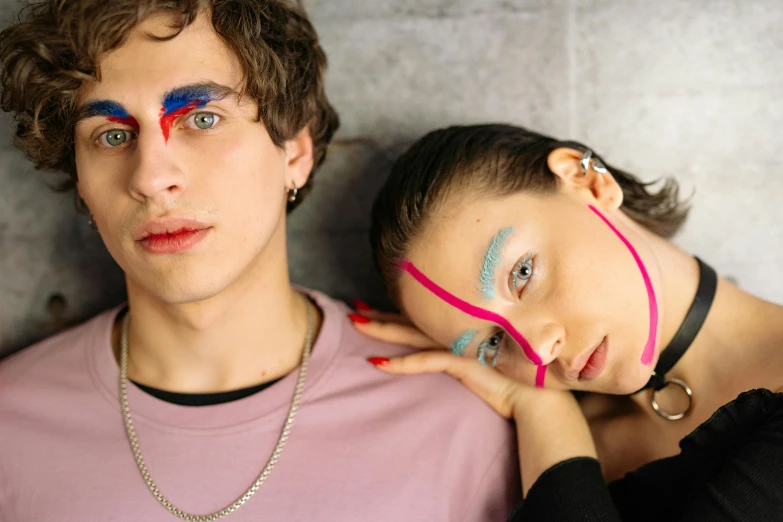 young man and woman dressed in unusual makeup