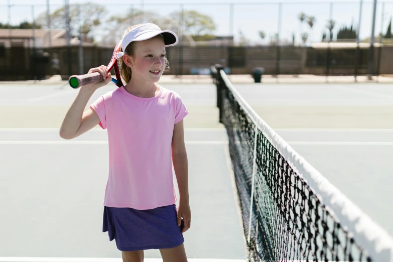 a girl on a tennis court getting ready to serve the ball